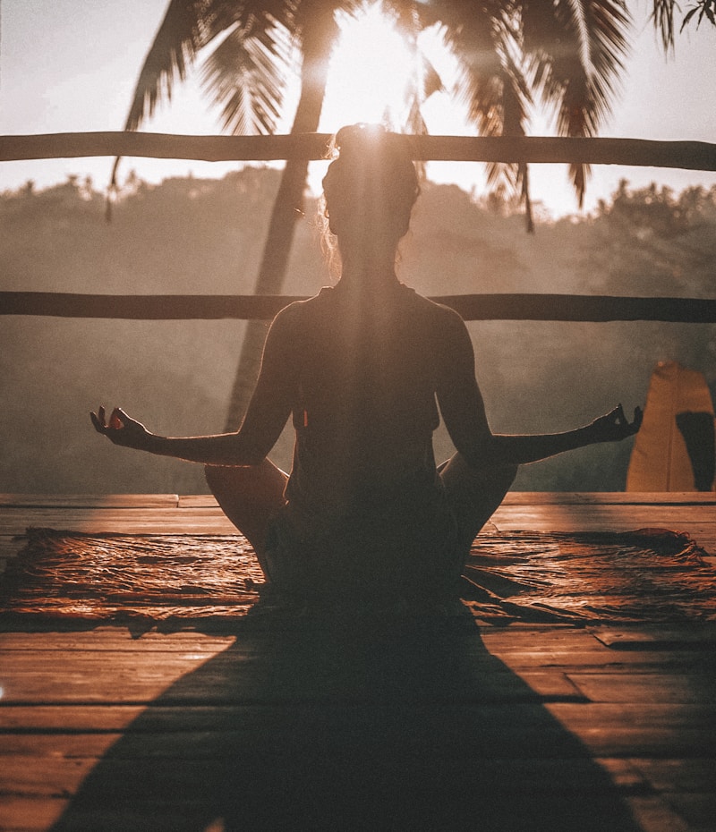 Person practicing calm morning wellness routine by the coast